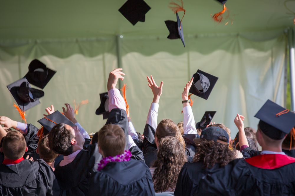 Graduates tossing caps at commencement