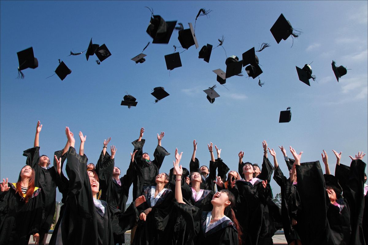 Students celebrating graduation on campus